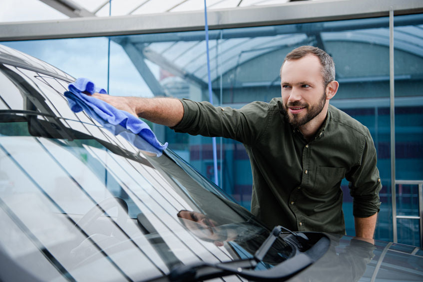 Man Cleaning Car Window