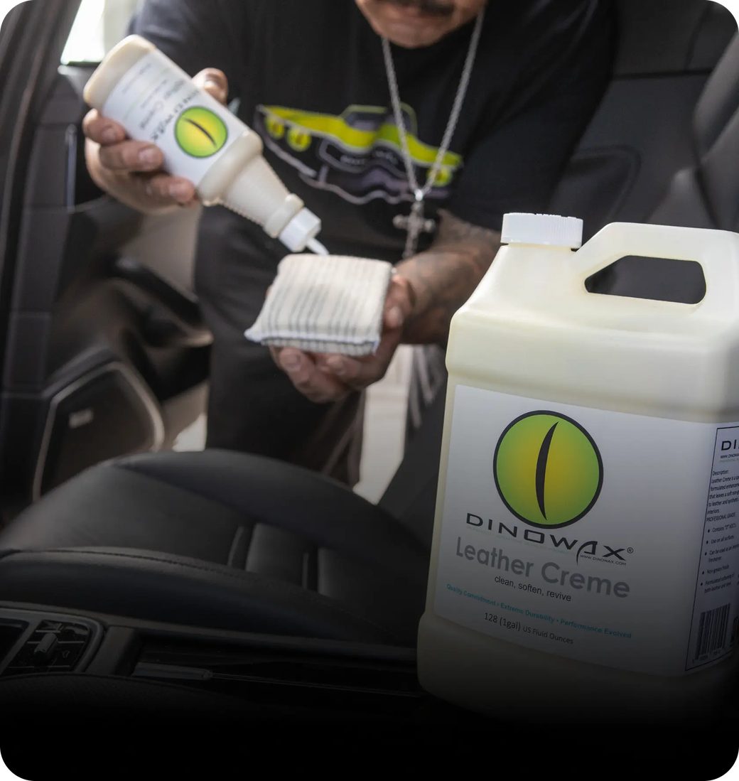 Person applying leather creme to a car seat with a cloth.
