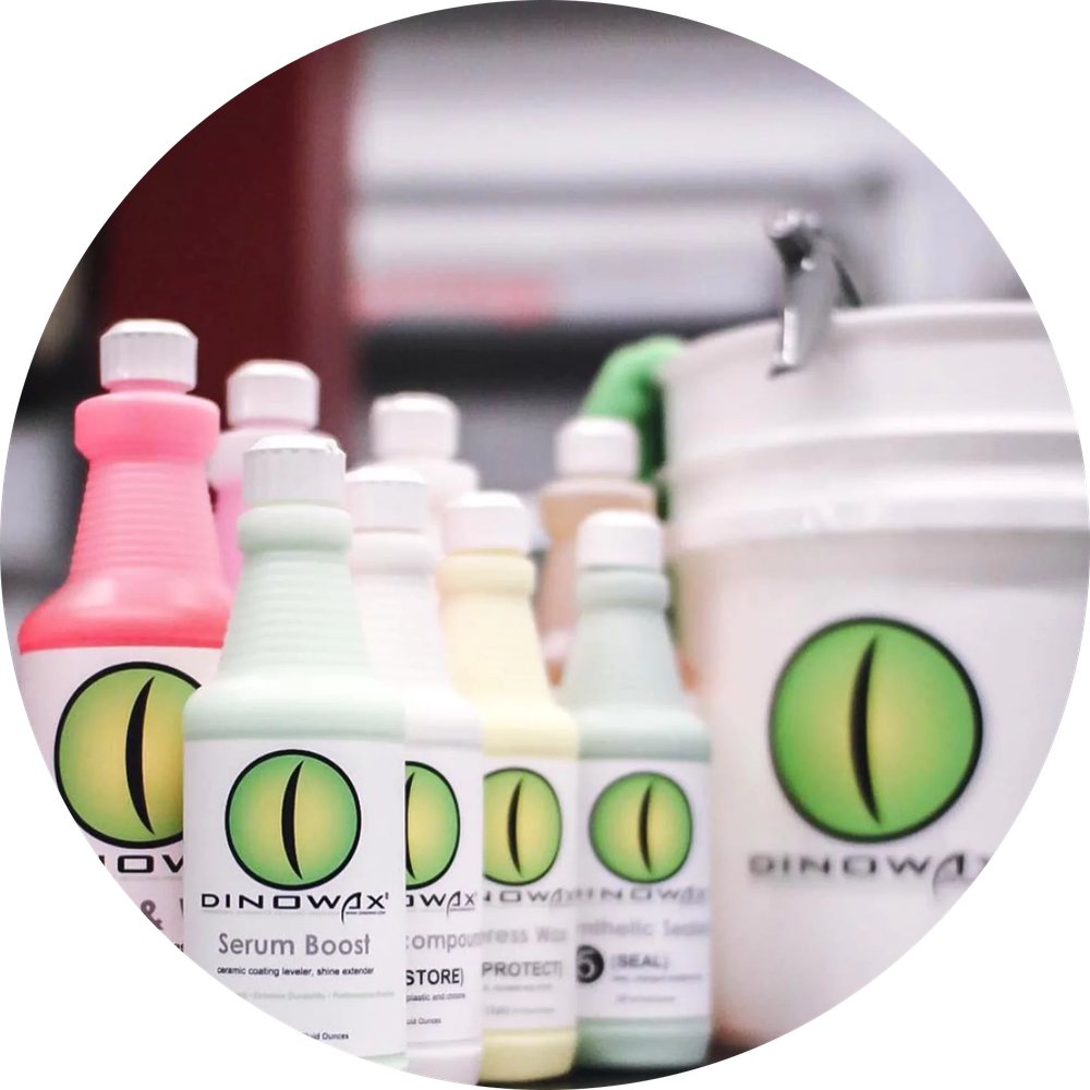 A line-up of Dinowax bottles and a branded bucket