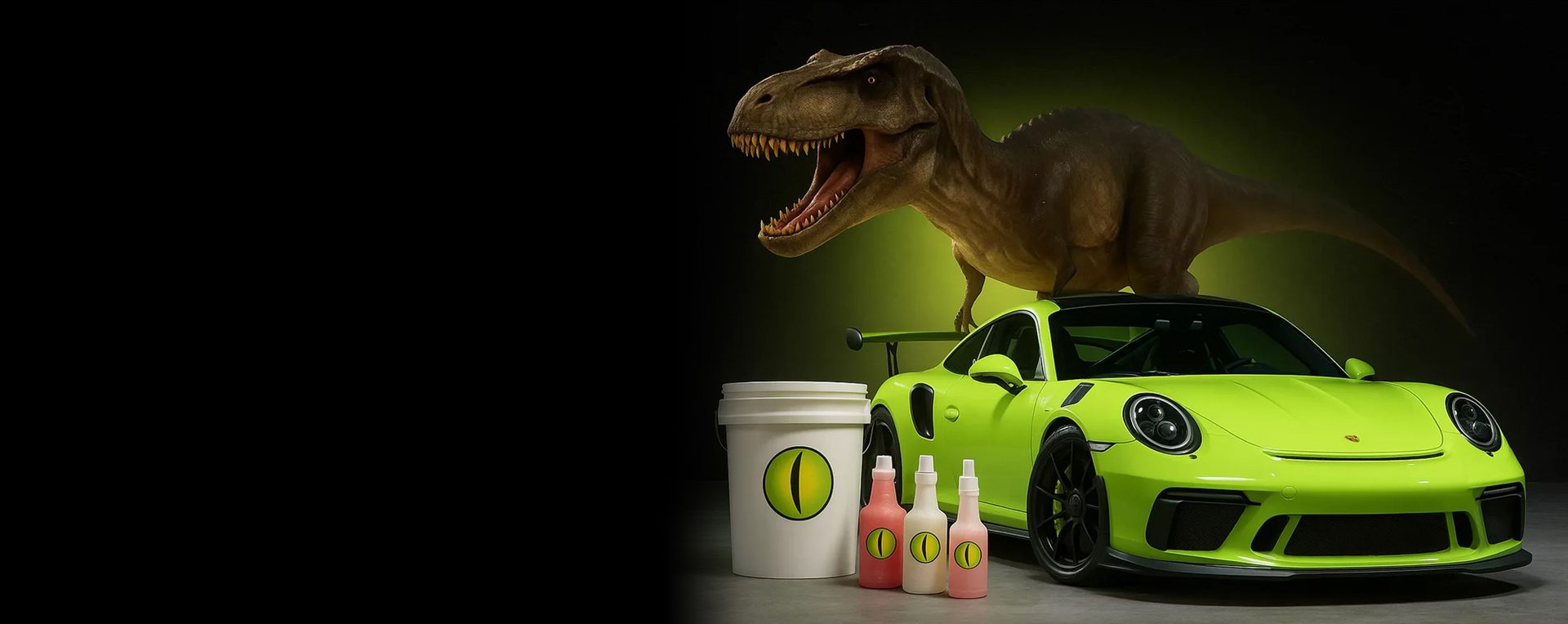 Dinowax detailing products in front of a green sports car